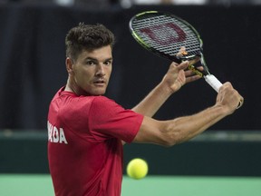 Canada's Frank Dancevic returns to Chile's Christian Garin during Davis Cup tennis World Group playoff singles action in Halifax on Friday, September 16, 2016. Captain Frank Dancevic said his team stuck to its motto during a critical 3-2 road win over Slovakia that gave Canada a berth in the Davis Cup Finals.