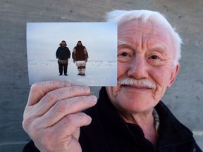 Inuit elder Piita Irniq holds a photograph in Ottawa on Wednesday, Dec. 21, 2016, taken in 1984 of himself and Marius Tungilik while seal hunting 25 miles outside Rankin Inlet. Inuit leaders say Canada's decision to stay charges against a priest accused of sex abuse is traumatizing the victims all over game.