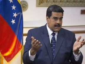 Venezuela's President Nicolas Maduro speaks during an interview with The Associated Press at Miraflores presidential palace in Caracas, Venezuela, Thursday, Feb. 14, 2019. Amnesty International is accusing Venezuelan police and forces loyal to Maduro of hundreds of human rights abuses following the start of pro-democracy protests in the last month.