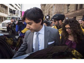 Jian Ghomeshi leaves court with his sister Jila, right, after signing a peace bond in Toronto, Wednesday, May 11, 2016. The New York Review of Books has announced two replacements for its former top editor who was ousted last fall amid controversy over an essay by disgraced former CBC radio host Ghomeshi.