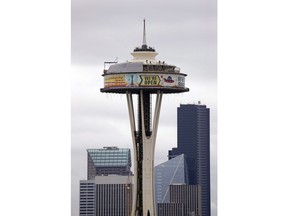 In this Feb. 7, 2018, file photo, workers climb atop the roof of the Space Needle, where most of the top is surrounded by a massive work platform, scaffolding and protective covering, as work on a major remodel of the iconic observation tower continues in Seattle. Wondering what the climate in your city will be in a few decades? An unusual study published today suggests you look about 1,000 kilometres to the south. Vancouver will feel a lot like Seattle and Calgary's weather will resemble what folks in Spearfish, South Dakota, now experience.