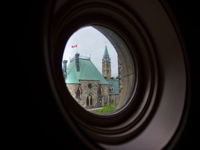 Parliament Hill is pictured through an East Block window in Ottawa on Thursday, May 29, 2014. The organization in charge of providing physical security to Parliament is looking to up its cybersecurity.