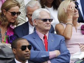 Canada's High Commissioner to London Gordon Campbell, center, sits in the Royal Box on centre court prior to the women's singles final between Eugenie Bouchard of Canada and Petra Kvitova of the Czech Republic at the All England Lawn Tennis Championships in Wimbledon, London, Saturday July 5, 2014. A British newspaper says police in London are investigating an allegation of sexual assault made against former British Columbia premier Gordon Campbell.