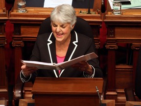 Finance Minister Carole James shares a laugh with a colleague before delivering the budget speech from the legislative assembly at Legislature in Victoria, B.C., on February 20, 2018.