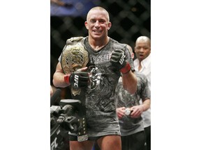 Georges St. Pierre celebrates his TKO victory over B.J. Penn after their UFC welterweight mixed martial art title bout Saturday, Jan. 31, 2009 in Las Vegas. The Canadian Museum of History in Gatineau, Que., has acquired the championship belt the mixed martial arts fighter from Montreal won at UFC 94 in 2009.