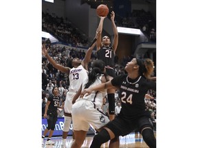 South Carolina's Mikiah Herbert Harrigan (21) makes a basket as Connecticut's Christyn Williams (13) defends during the first half of an NCAA college basketball game, Monday, Feb. 11, 2019, in Hartford, Conn.
