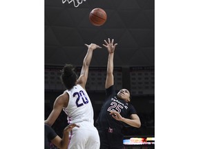 Temple's Mia Davis (25) shoots a basket over Connecticut's Olivia Nelson-Ododa (20) during the first half of an NCAA college basketball game, Saturday, Feb. 9, 2019, in Storrs, Conn.