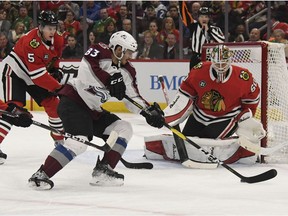 Colorado Avalanche left wing Matt Nieto (83) skates in on Chicago Blackhawks goaltender Collin Delia (60) as defenseman Connor Murphy (5) defends during the first period of an NHL hockey game Friday, Feb. 22, 2019, in Chicago.