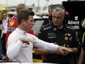 Jamie McMurray, left, gestures as he talks to a crew member during practice for the NASCAR Daytona 500 auto race, Saturday, Feb. 16, 2019, at Daytona International Speedway in Daytona Beach, Fla.