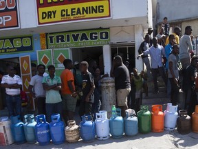 Residents line up to buy propane gas in Port-au-Prince, Haiti, Monday, Feb. 18, 2019. Businesses and government offices slowly reopened across Haiti on Monday after more than a week of violent demonstrations over prices that have doubled for food, gas and other basic goods in recent weeks and allegations of government corruption.