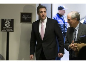 Michael Cohen, left, President Donald Trump's former lawyer, arrives to testify before a closed door hearing of the Senate Intelligence Committee accompanied by his lawyer Lanny Davis of Washington, on Capitol Hill, Tuesday, Feb. 26, 2019, in Washington.