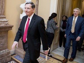 Rep. John Barrasso, R-Wyo., left, and Sen. Rob Portman, R-Ohio, right, walk to a meeting with Republican Senate leadership at the offices of Senate Majority Leader Mitch McConnell of Ky. on Capitol Hill, Monday, Feb. 11, 2019, in Washington.