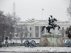 Snow falls on the White House during a winter storm, Wednesday, Feb. 20, 2019, in Washington.