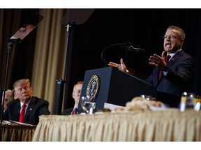 President Donald Trump listens as Gary Haugen, Chief Executive Officer and Founder of International Justice Mission, speaks during the National Prayer Breakfast, Thursday, Feb. 7, 2019, in Washington.