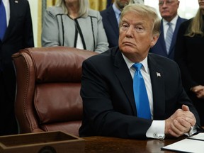 President Donald Trump pauses during a signing event for "Space Policy Directive 4" in the Oval Office of the White House, Tuesday, Feb. 19, 2019, in Washington.