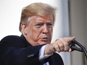 President Donald Trump points to a member of the media while taking questions after speaking during an event in the Rose Garden at the White House to declare a national emergency in order to build a wall along the southern border, Friday, Feb. 15, 2019 in Washington.