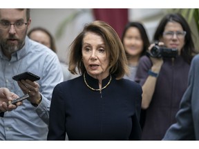 Speaker of the House Nancy Pelosi, D-Calif., walks with reporters to a Democratic Caucus meeting the morning after President Donald Trump's State of the Union speech, on Capitol Hill in Washington, Wednesday, Feb. 6, 2019.