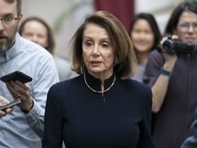 Speaker of the House Nancy Pelosi, D-Calif., walks with reporters to a Democratic Caucus meeting the morning after President Donald Trump's State of the Union speech, on Capitol Hill in Washington, Wednesday, Feb. 6, 2019.