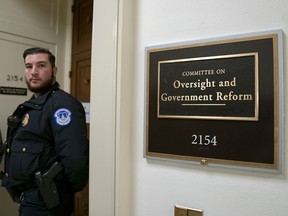 A U.S. Capitol Police office stands guard at the entrance to the House Oversight and Reform Committee as the Democrat-led panel questions Michael Cohen, President Donald Trump's former personal lawyer, on Capitol Hill in Washington, Wednesday, Feb. 27, 2019.