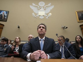 Michael Cohen, President Donald Trump's former personal lawyer, listens as he finishes a day of testimony to the House Oversight and Reform Committee, on Capitol Hill in Washington, Wednesday, Feb. 27, 2019.