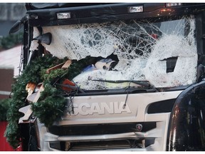 FILE - In this Dec. 20, 2016 file photo Christmas decoration sticks in the smashed window of the cabin of a truck which ran into a crowded Christmas market Monday evening killing several people in Berlin, Germany. The German government has rejected media reports claiming authorities sought to cover up the involvement of a second man in the deadly 2016 truck attack on a Berlin Christmas market by deporting him.