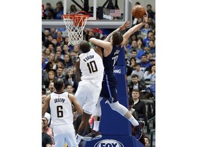 Dallas Mavericks forward Luka Doncic, right, is fouled going to the basket for a shot by Indiana Pacers center Kyle O'Quinn, left, as Cory Joseph (6) watches in the first half of an NBA basketball game in Dallas, Wednesday, Feb. 27, 2019. O'Quinn was issued a flagrant foul on the play.