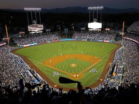 In this Oct. 25, 2017, file photo, the Houston Astros and the Los Angeles Dodgers play in Game 2 of the baseball World Series at Dodger Stadium in Los Angeles.