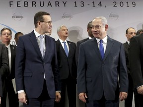 File -- In this Thursday, Feb. 14, 2019 photo Poland's Prime Minister Mateusz Morawiecki, left, and Israeli Prime Minister Benjamin Netanyahu, right, attend a group photo during a meeting in Warsaw, Poland. Poland's prime minister canceled plans for his country to send a delegation to meeting in Jerusalem on Monday after the acting Israeli foreign minister Israel Katz said that Poles "collaborated with the Nazis" and "sucked anti-Semitism from their mothers' milk".