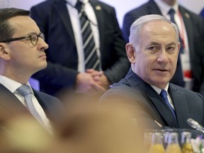 File -- In this Thursday, Feb. 14, 2019 photo Poland's Prime Minister Mateusz Morawiecki, left, and Israeli Prime Minister Benjamin Netanyahu, right, attend a meeting in Warsaw, Poland. Poland's prime minister canceled plans for his country to send a delegation to meeting in Jerusalem on Monday after the acting Israeli foreign minister Israel Katz said that Poles "collaborated with the Nazis" and "sucked anti-Semitism from their mothers' milk".