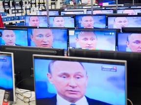 TV sets in a shop in Moscow on April 16, 2015 during the broadcast of Russian President Vladimir Putin's annual televised phone-in with the nation.