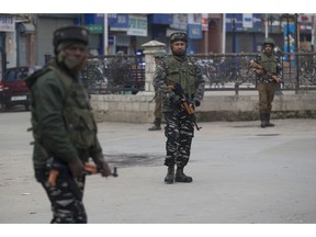 Indian paramilitary soldiers stand guard in a closed market in Srinagar, Indian controlled Kashmir, Saturday, Feb. 23, 2019. Police have arrested at least 200 activists seeking the end of Indian rule in disputed Kashmir, officials said Saturday, escalating fears among already wary residents that a sweeping crackdown could touch off renewed anti-India protests and clashes.