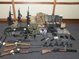 This image provided by the U.S. District Court in Maryland shows a photo of firearms and ammunition that was in the motion for detention pending trial in the case against Christopher Paul Hasson. Prosecutors say that Hasson, a Coast Guard lieutenant is a "domestic terrorist" who wrote about biological attacks and had a hit list that included prominent Democrats and media figures. He is due in court on Feb. 21 in Maryland. Prosecutors say Hasson espoused extremist views for years. Court papers say Hasson described an "interesting idea" in a 2017 draft email that included "biological attacks followed by attack on food supply."