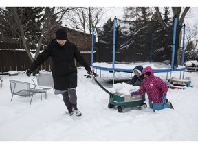 Vicki Maruyama plays with her daughters Akari, centre, and Arisa, left, in Edmonton on Wednesday, February 20, 2019. Maruyama says she feels like she's not Canadian enough after her daughters were denied citizenship.THE CANADIAN PRESS/Jason Franson