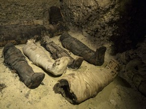 Recently discovered mummies lie in a burial chamber in the desert province of Minya, south of Cairo, Egypt, Saturday, Feb. 2, 2019.