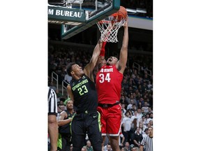 Ohio State's Kaleb Wesson, right, shoots and draws a foul against Michigan State's Xavier Tillman (23) during the first half of an NCAA college basketball game, Sunday, Feb. 17, 2019, in East Lansing, Mich.