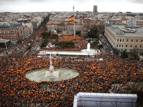 Thousands of demonstrators hold Spanish flags during a protest in Madrid, Spain, on Sunday, Feb.10, 2019. Thousands of Spaniards in Madrid are joining a rally called by right-wing political parties to demand that Socialist Prime Minister Pedro Sanchez step down.