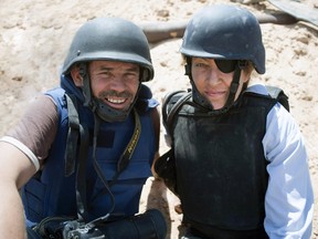 This image released by Arrow Media shows photographer Paul Conroy, left, with war correspondent Marie Colvin in Misrata, Libya.