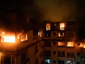 This handout picture taken and released by the Paris firefighters brigade (BSPP) in the night of February 5, 2019 shows a fire in a building in Erlanger street in the 16th arrondissement in Paris, that killed 8 people.