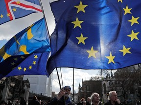 Demonstrators protest with European flags outside the Houses of Parliament in London, England, on Feb. 20, 2019.