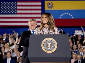 First lady Melania Trump, accompanied by President Donald Trump, smiles as she speaks in front of a Venezuelan American community at Florida Ocean Bank Convocation Center at Florida International University in Miami, Fla., Monday, Feb. 18, 2019, as Trump speaks out against President Nicolas Maduro's government and its socialist policies.