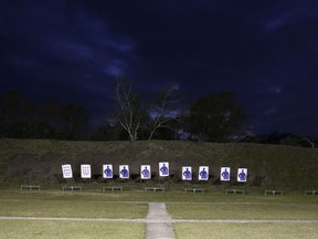 In this Jan. 30, 2019, photo, light casts over a group of targets used by the "guardians" during a training session to respond to active shooters in Okeechobee, Fla. Okeechobee is one of the Florida districts that have started training and arming non-instructional personnel in the aftermath of the Marjory Stoneman Douglas High School shooting. Authorities keep the identities of these "guardians" secret, citing security reasons.