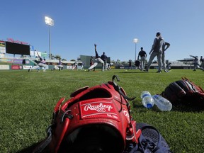 A Rawlings glove sits on the field, as pitchers and catchers report for their first workout at their spring training baseball facility in Ft. Myers, Fla., Thursday, Feb. 14, 2019.