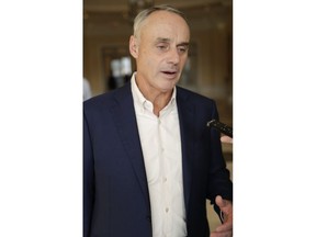 Rob Manfred, commissioner of Major League Baseball, talks to reporters at the end of the day's conferences at MLB baseball owners meetings Thursday, Feb. 7, 2019, in Orlando, Fla.