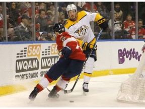 Nashville Predators center Ryan Johansen (92) battles Florida Panthers right wing Evgenii Dadonov (63) for the puck in the first period of an NHL hockey game, Friday Feb. 1, 2019, in Sunrise, Fla.