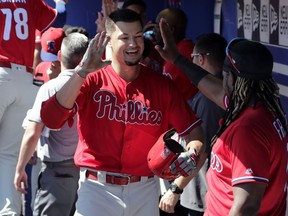 Philadelphia Phillies' Dylan Cozens, left, celebrates with Maikel Franco after hitting a three-run home run in the first inning of a spring training baseball game against the Toronto Blue Jays, Thursday, Feb. 28, 2019, in Dunedin, Fla.