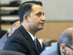 Former Palm Beach Gardens police officer Nouman Raja listens to defense attorney Scott Richardson give opening statements in Raja's trial, Tuesday, Feb. 26, 2019, in West Palm Beach, Fla. Raja is charged with the fatal 2015 shooting of a stranded black motorist, 31-year-old Corey Jones.