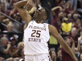 Florida State's Mfiondu Kabengele celebrates after hitting a three-point basket in the first half of an NCAA college basketball game against Louisville, Saturday, Feb. 9, 2019, in Tallahassee, Fla.