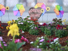 A plaque for Jaime Guttenberg, one of the victims of the Parkland, Fla., school shooting is shown at a memorial outside Marjory Stoneman Douglas High School during the one-year anniversary of the shooting, Thursday, Feb. 14, 2019.  A year ago on Thursday, 14 students and three staff members were killed when a gunman opened fire at the high school.