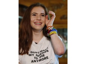 In this, Thursday, Feb. 7, 2019 photo, Sam Deitsch wipes a tear from her eye as she speaks during an interview with The Associated Press at her home in Parkland, Fla. Deitsch and her two brothers crisscrossed the country after the Marjory Stoneman Douglas High School massacre, helping to register young voters and advocate for stricter gun laws.