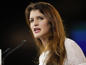 In this Nov. 18, 2017 file photo, French secretary of state for women's rights Marlene Schiappa delivers a speech in Chassieu, near Lyon, central France.  Twelve women, journalists and witnesses go on trial Monday Feb. 4, 2019, for alleged defamation of prominent French lawmaker Denis Baupin after their accusations of sexual misconduct forced his resignation, although Baupin denied any misconduct.